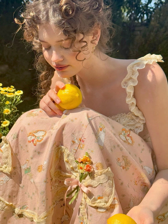 Whimsical cottagecore dress adorned with lace ruffles and floral prints, as a young woman gently holds a lemon, evoking a nostalgic summer moment.