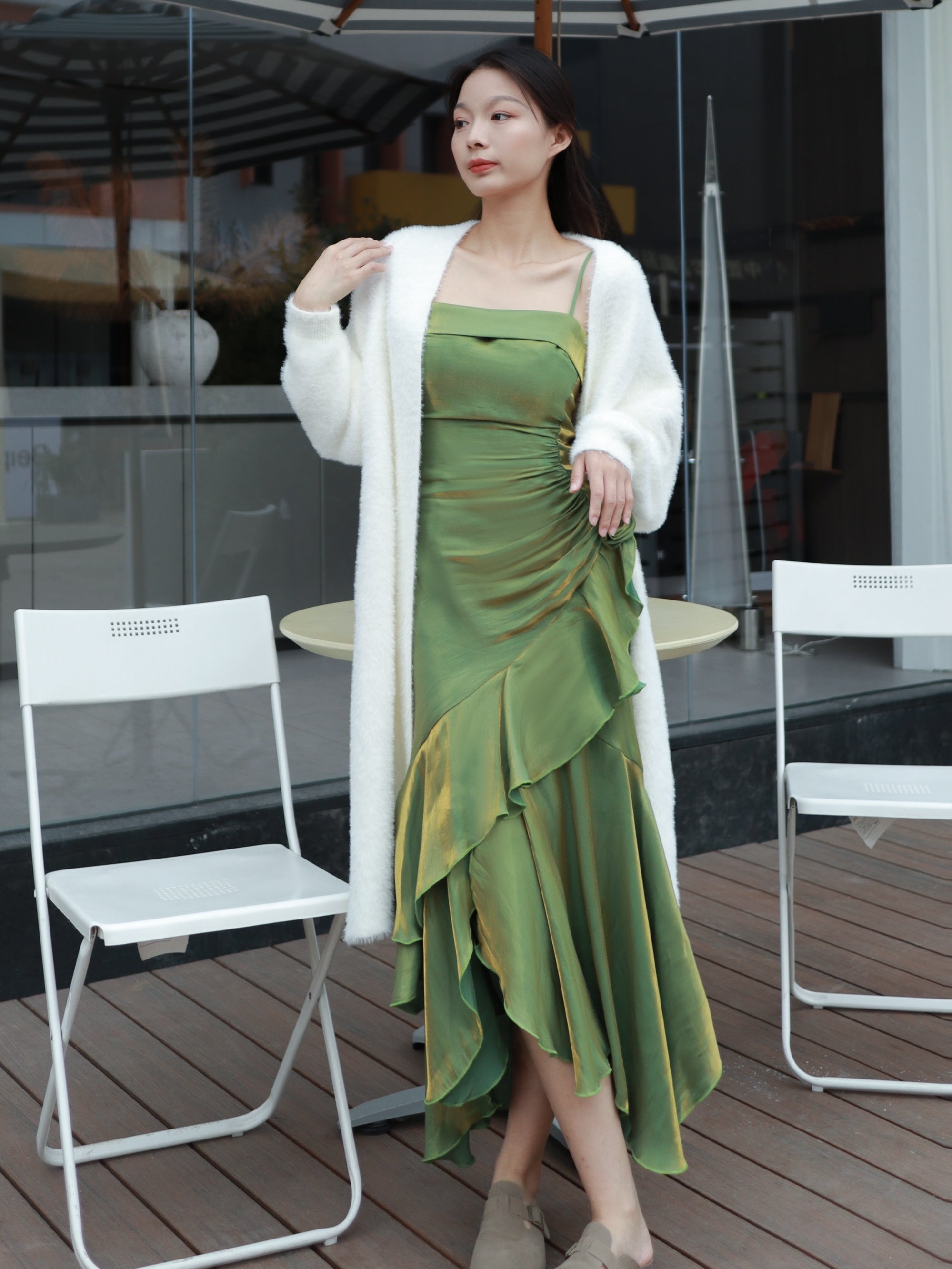 Dreamy garden green gown with fitted bodice, worn on a balcony overlooking a lush landscape.