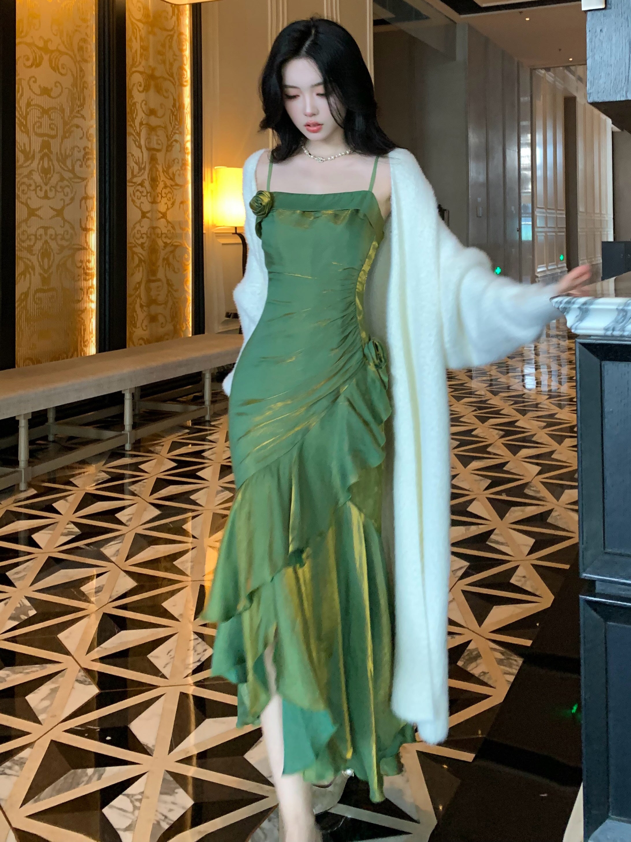 Elegant green formal dress in motion, reflecting light beautifully in a hotel hallway.
