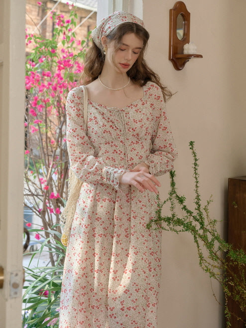Full-length view of a woman in a cottagecore floral outfit, standing by an open door, surrounded by a vintage aesthetic atmosphere.