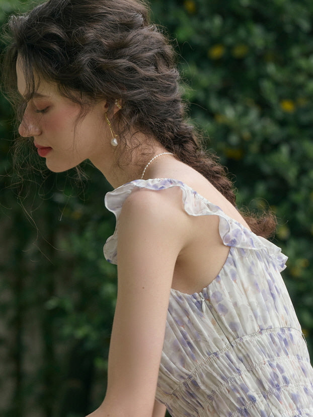 Woman with braided hair wearing a sleeveless cottagecore floral dress with ruffle straps, aesthetic side profile against a garden background