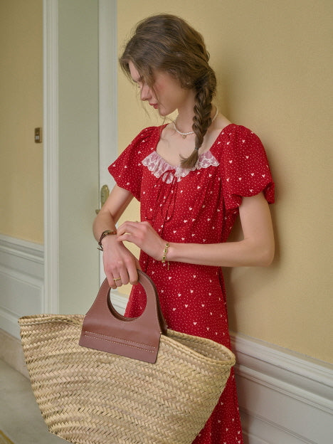 Red retro dress with lace neckline styled with a woven basket bag, capturing a cottagecore-inspired summer outfit.