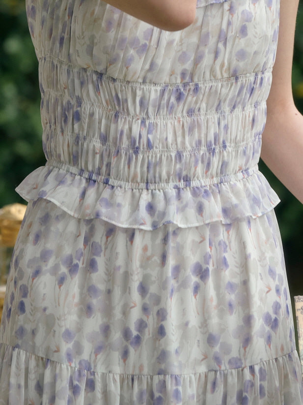 Detail view of a smocked waist and ruffled trim on a floral cottagecore dress, soft and romantic style.