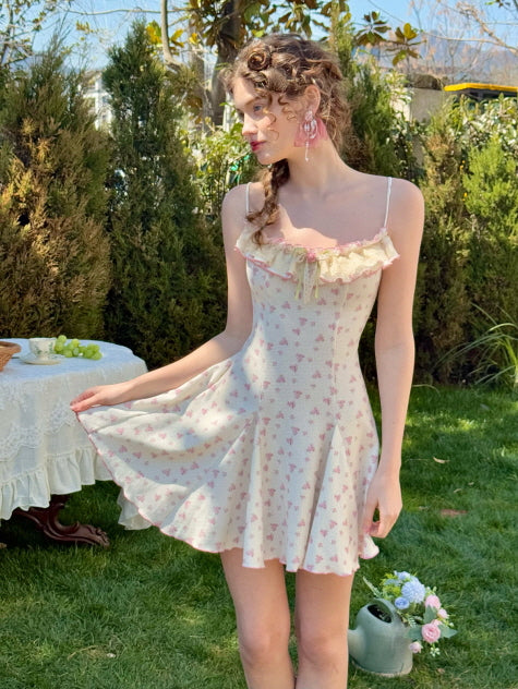 Model holding the hem of a flared floral dress, showcasing the gentle flow of the fabric in a dreamy, fairytale-like garden scene.