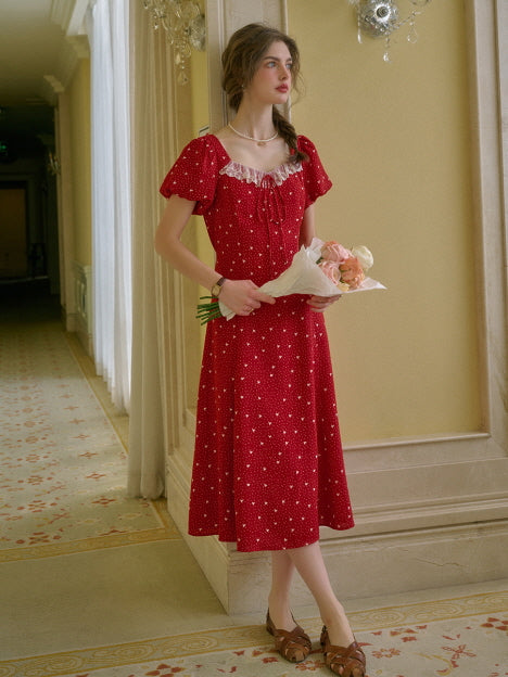A soft and romantic red summer dress with lace details and puff sleeves, styled with roses in a dreamy vintage hallway.