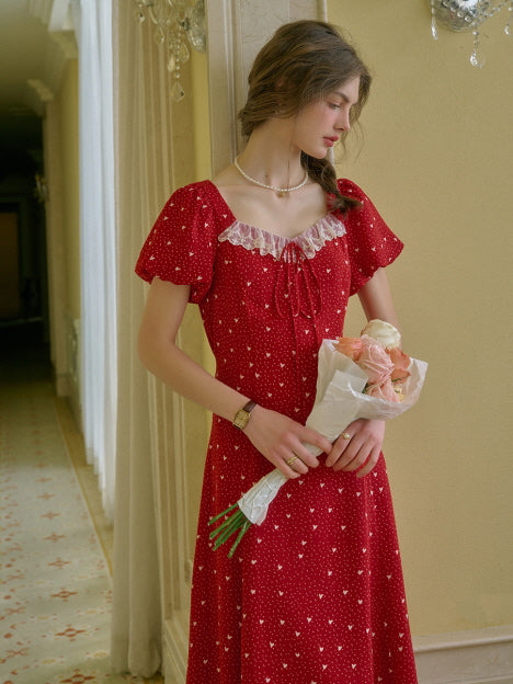 Close-up of a red retro dress with lace trim, styled casually with a bouquet of roses for a beautiful and feminine summer mood.