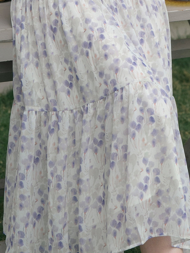 Close-up of a tiered skirt with a delicate purple floral print, cottagecore aesthetic outfit.