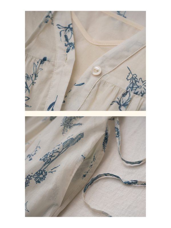 Vintage-inspired floral print dress with delicate blue botanical patterns, featuring a classic button-down front and tie details, laid flat to showcase fabric texture