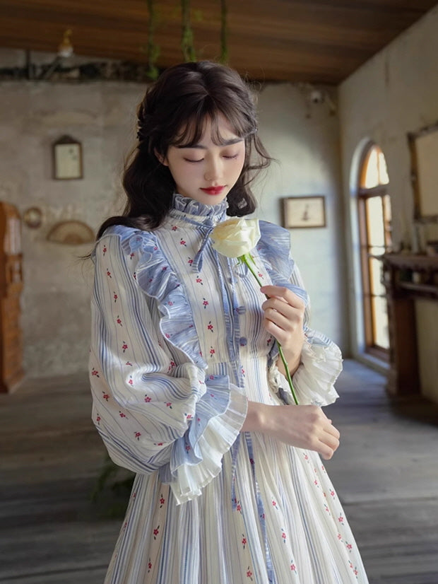 A woman in a fairytale-inspired vintage dress with floral stripes, holding a white rose gracefully in an aesthetic room.