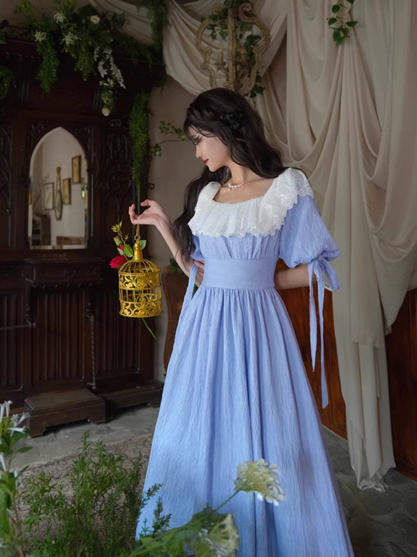 A fairytale blue vintage dress with lace details, styled in a dreamy fantasy garden setting, aesthetic and romantic outfit.