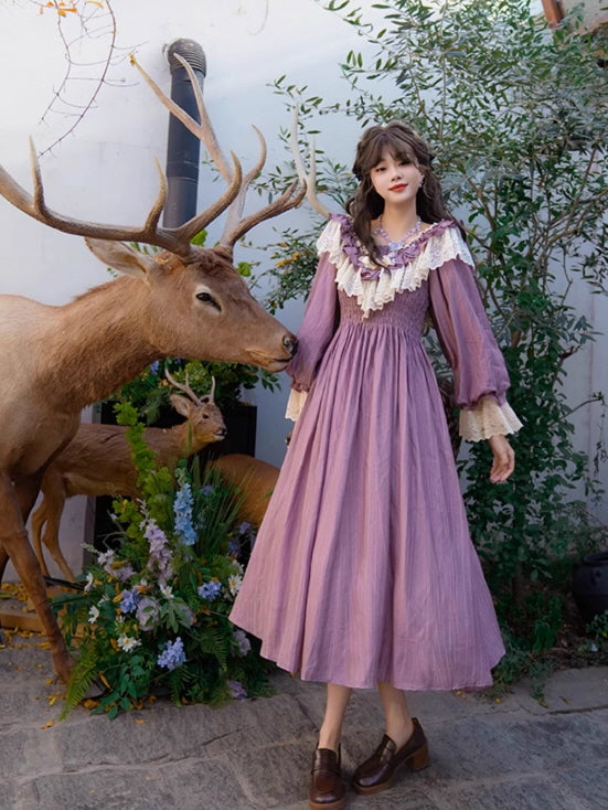 A fantasy vintage outfit with a purple fairytale dress and lace details, styled in a floral garden next to a deer statue, giving a dreamy and aesthetic atmosphere.