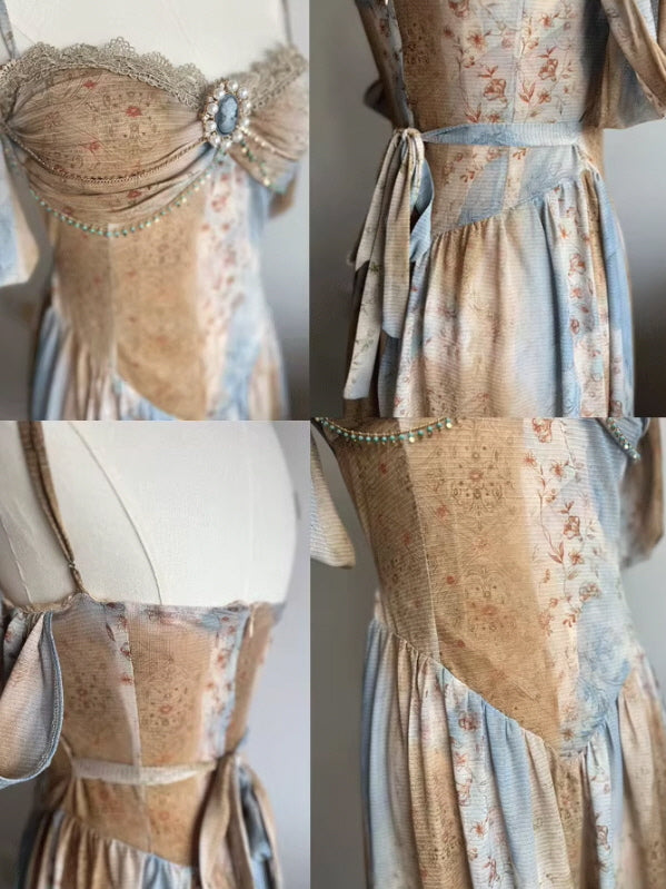 Close-up of a vintage-style gown with a floral pattern, lace trim, and a pearl-embellished brooch, showcasing the intricate corset bodice and waist ties.