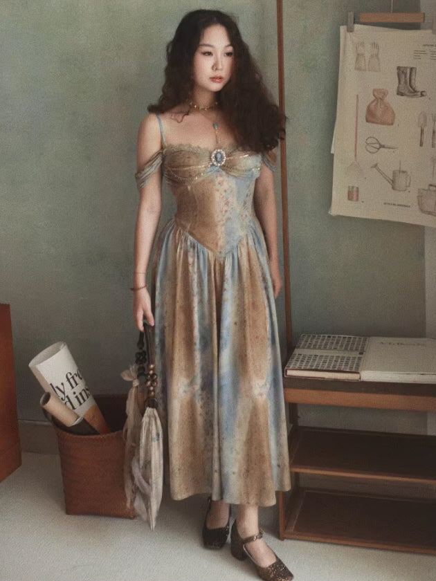 A woman in a princesscore, vintage blue and gold gown with delicate lace detailing and a jeweled centerpiece, posing elegantly in a cozy, cottagecore-themed room.