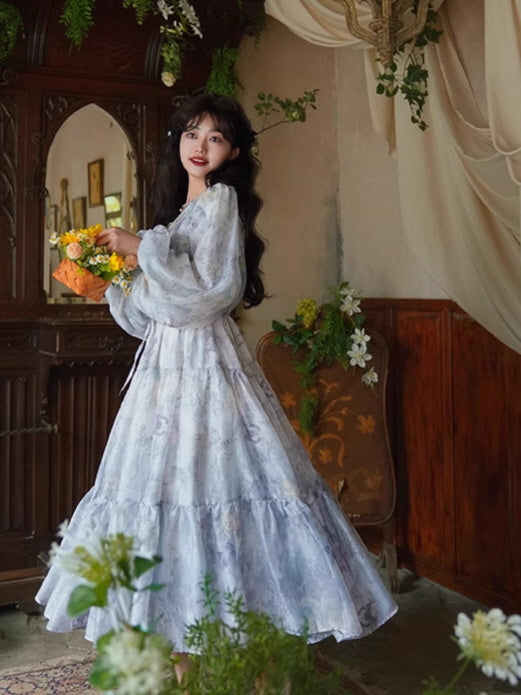 Side view of a dreamy blue floral gown with a flowing, layered skirt and delicate puff sleeves, creating a whimsical fary aesthetic.