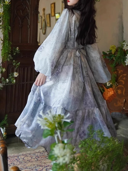 Back view of a flowing blue floral gown with tiered ruffles and voluminous long sleeves, creating a dreamy, ethereal silhouette in a fairytale-inspired room.