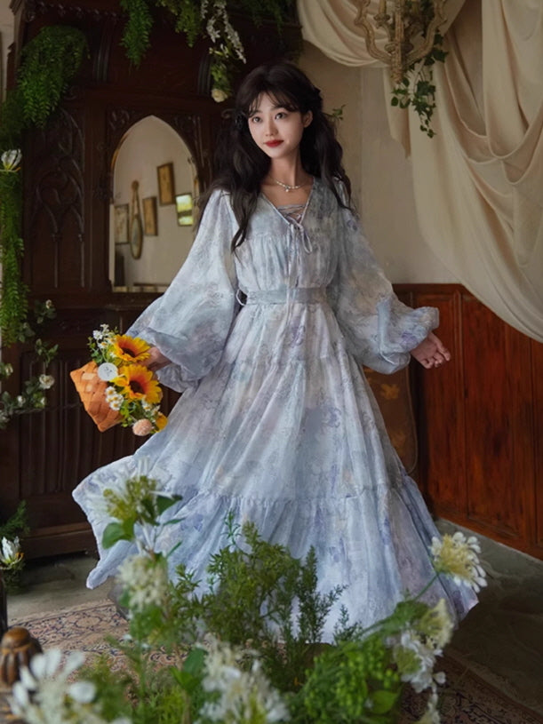 A fairytale-inspired lavender gown with soft floral prints, cinched waist, and billowy sleeves, styled with a sunflower bouquet for a whimsical vibe.
