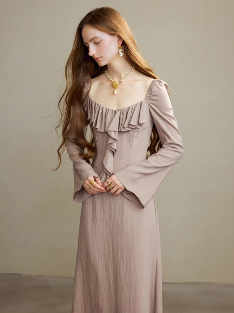 Model in a taupe ruffle long dress with long flared sleeves and a vintage-inspired square neckline, posing in a calm studio setting for a romantic cottagecore and fairycore outfit look.