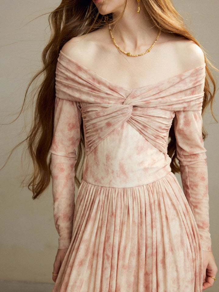 Close-up of the blush off-shoulder long dress showing the twisted draped neckline, fitted sleeves, and delicate marble-patterned fabric for a romantic vintage cottagecore look.