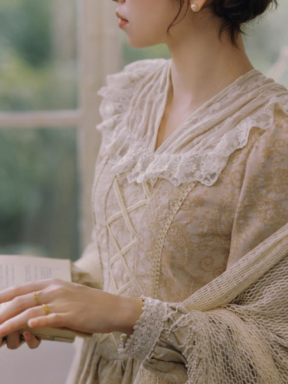 Close-up of a cream vintage lace dress with delicate ruffles and corset-style stitching, shown on a woman reading beside a softly lit window, romantic fairytale style.