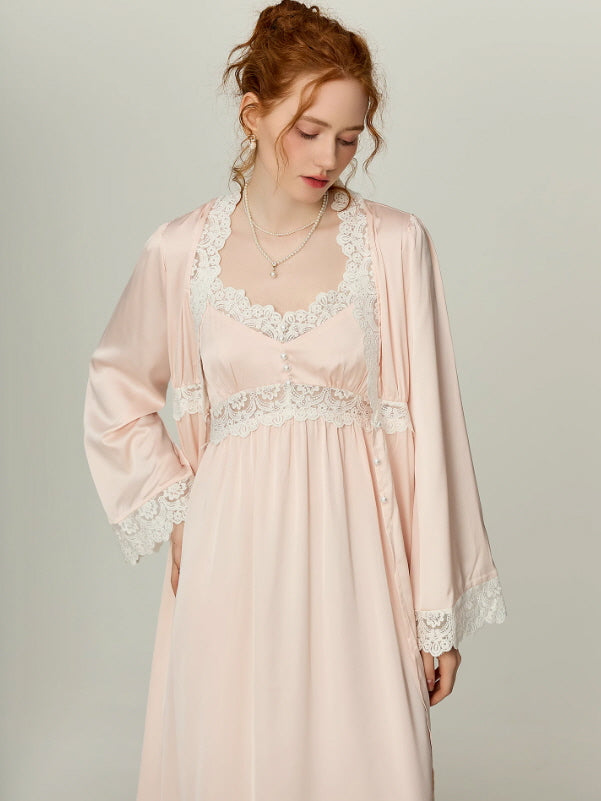 Model wearing blush pink nightgown and matching robe with white lace neckline and cuffs, soft cottagecore and vintage-inspired loungewear by Romantic Fairytale.