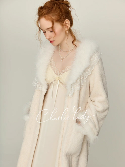 Model styling an ivory lace nightgown under a soft plush robe with faux fur shawl collar and lace edging, vintage-inspired princess aesthetic loungewear in a studio setting.