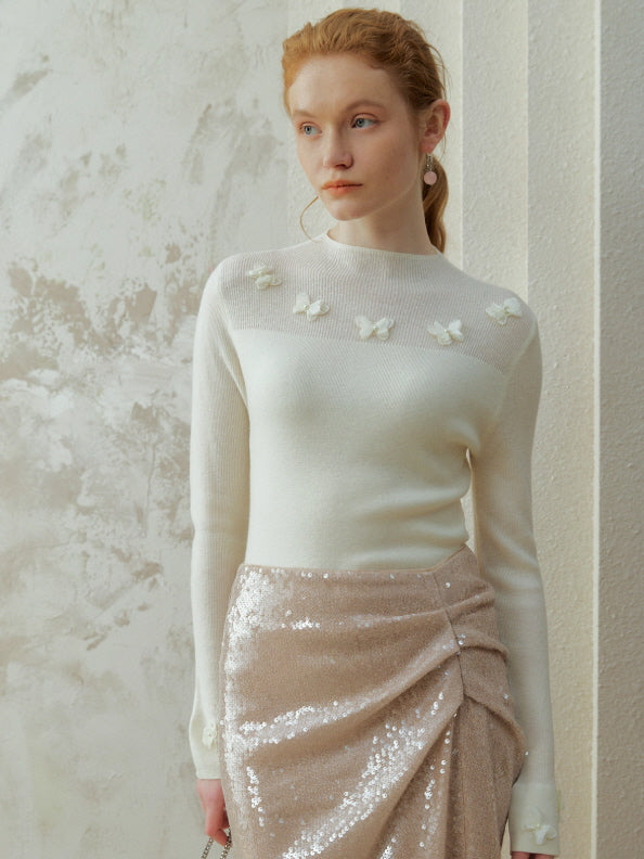 Model wearing an ivory butterfly detail knit top with delicate appliqué accents, styled in a romantic fairycore vintage outfit with an elegant everyday aesthetic.