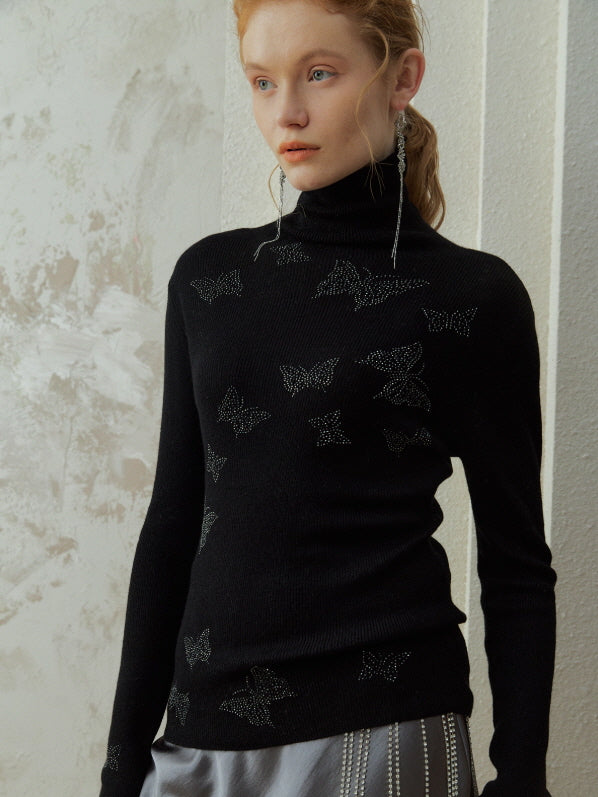 Model wearing a black butterfly detail turtleneck knit top with delicate shimmer accents, styled in a romantic fairycore vintage outfit with an elegant winter aesthetic.