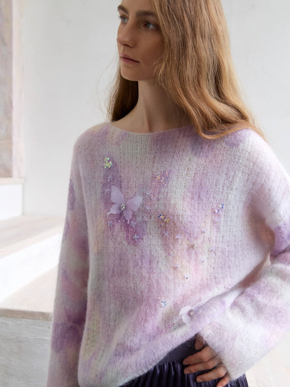 Pastel lilac watercolor knit top with delicate butterfly appliqué and subtle bead embellishments, styled in a soft fairycore and cottagecore aesthetic with a dreamy romantic mood.