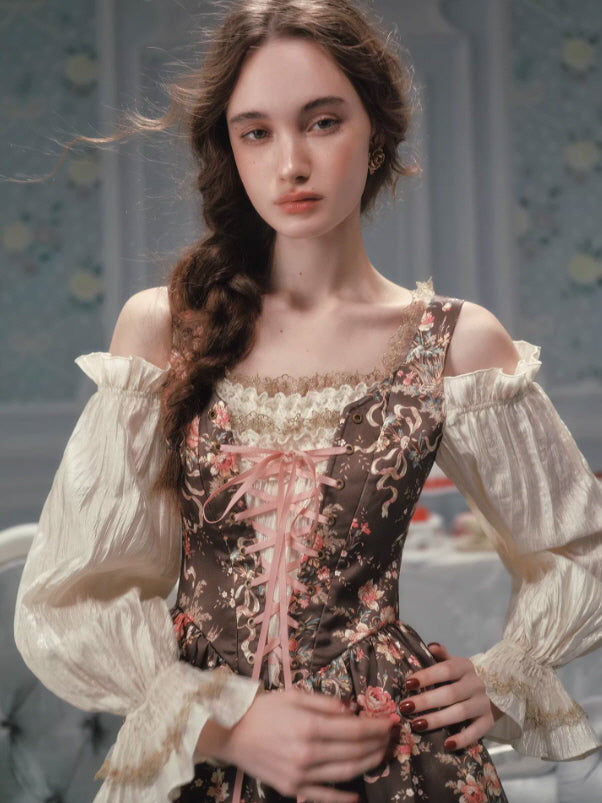Close-up of a vintage fairycore corset dress with a floral patterned bodice, soft lace neckline, pink ribbon lace-up front, and sheer gathered sleeves, creating a romantic woodland-inspired outfit.