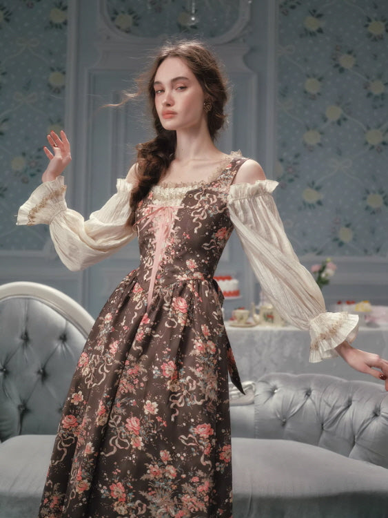 Romantic floral corset dress with sheer off-shoulder sleeves, featuring a vintage rose print, lace-trimmed bodice, and ribbon lace-up detail, styled in a fairycore woodland aesthetic interior.