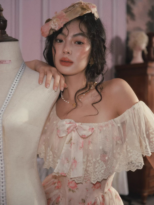 Close-up of sheer lace off-shoulder neckline with ribbon bow detail and delicate floral pattern dress