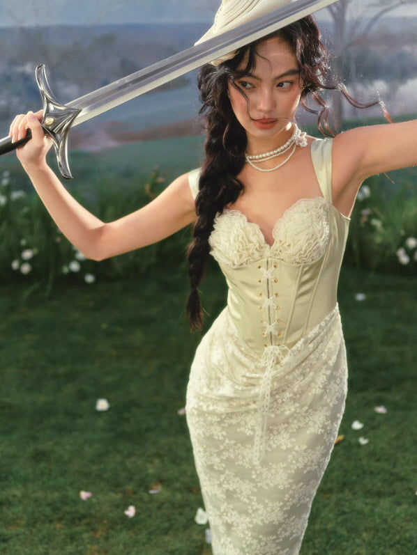 Close-up of lace corset bodice with ruched bust detail and vintage-inspired silhouette in soft green