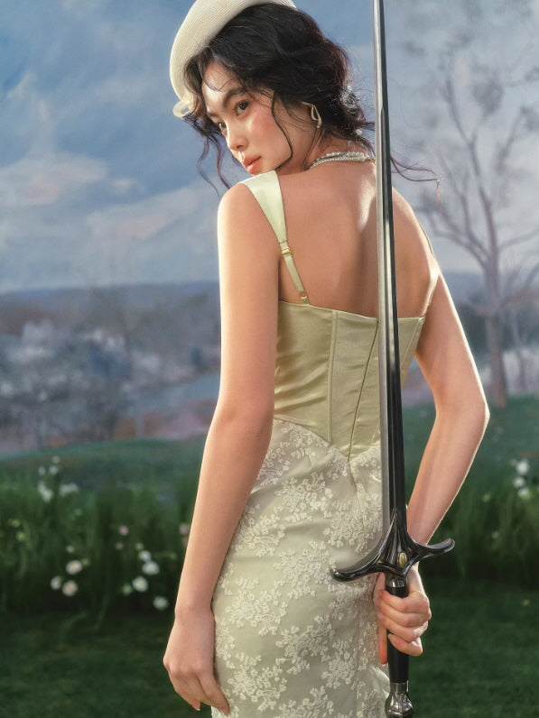 Back view of vintage corset midi dress with structured bodice and adjustable straps in soft green tone