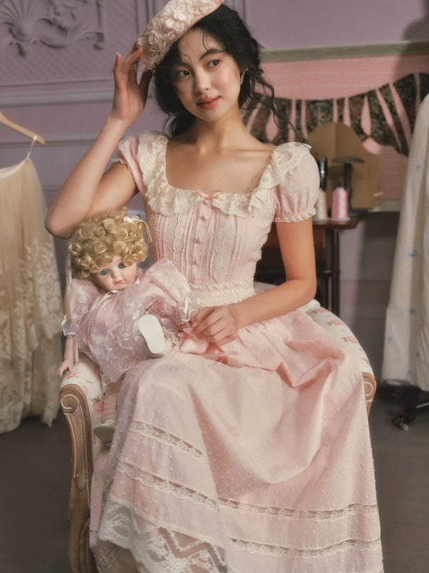 Elegant blush pink lace dress with textured fabric and romantic details, styled with vintage accessories