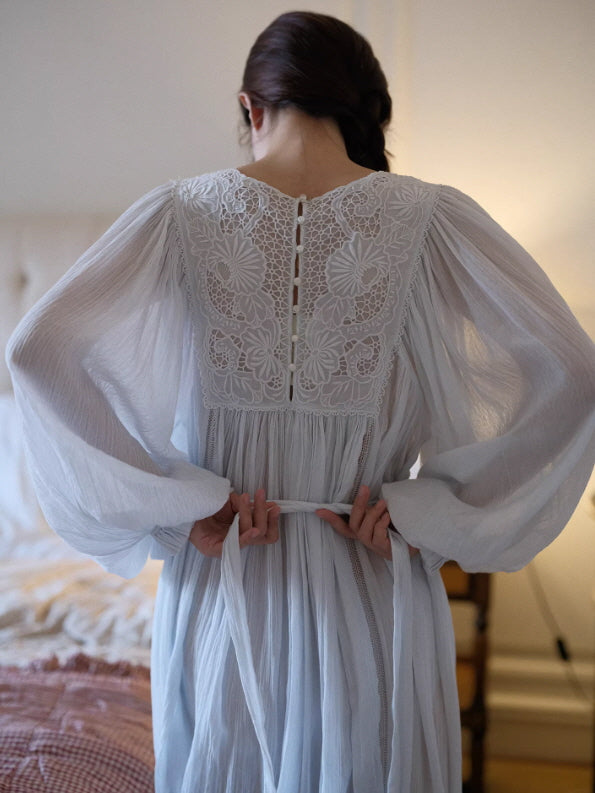 Back view of white lace nightgown with button closure and waist tie, airy long sleeves and elegant vintage design