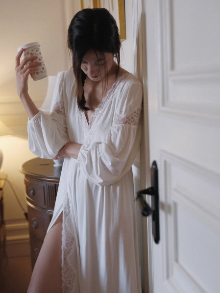 Flowy white nightgown with lace panel slit and puff sleeves, cozy indoor scene with warm lighting and relaxed mood
