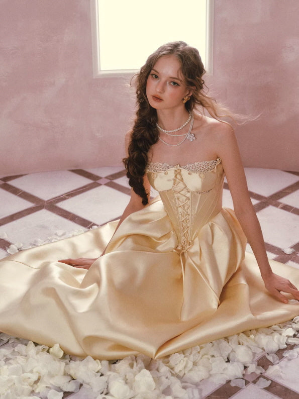 Elegant champagne gold corset gown with full skirt, vintage princess dress aesthetic in soft romantic setting