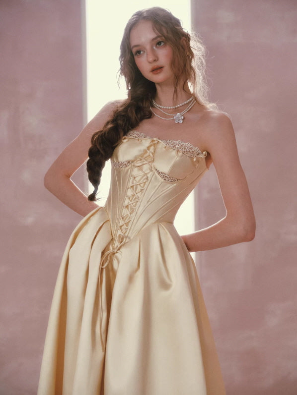 Strapless gold satin corset dress with lace detail and structured bodice, elegant vintage princess style