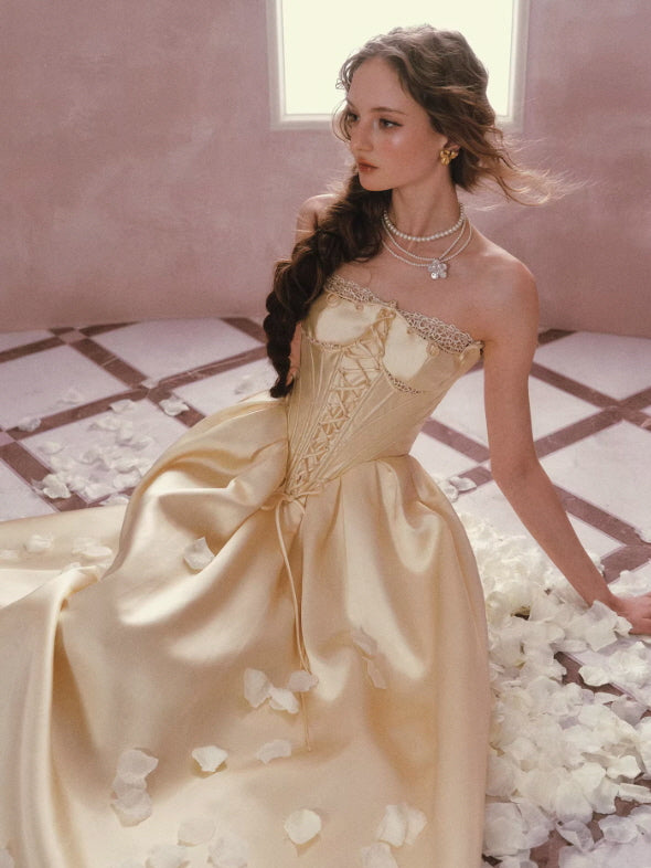 Golden satin princess dress with corset bodice and full skirt, romantic vintage aesthetic with soft lighting