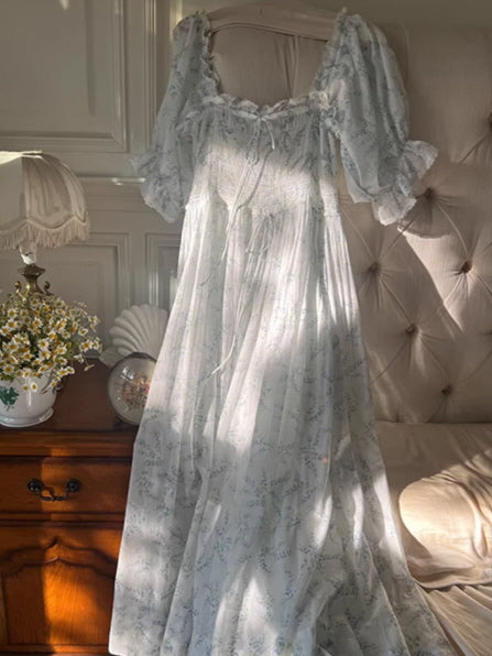 close up of smocked bodice puff sleeve floral dress, delicate ribbon and texture detail