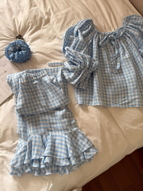 flat lay blue gingham pajama set with scrunchie ruffle hem pants and off shoulder blouse