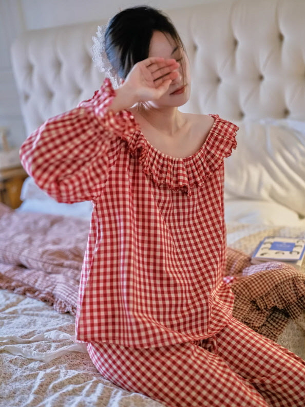Red gingham cotton pajama set with ruffled neckline, cozy cottagecore sleepwear on bed