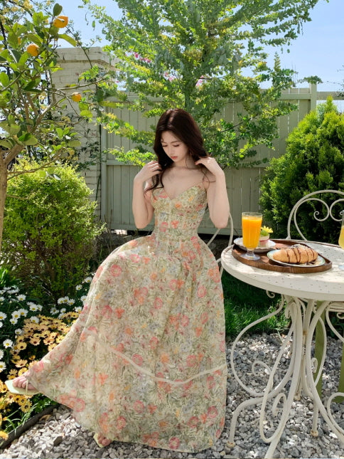 Floral spaghetti strap maxi dress styled at an outdoor garden café, romantic vacation dress