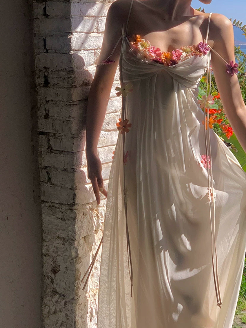 Romantic ivory maxi dress with 3D flower embellishments and draped bust design