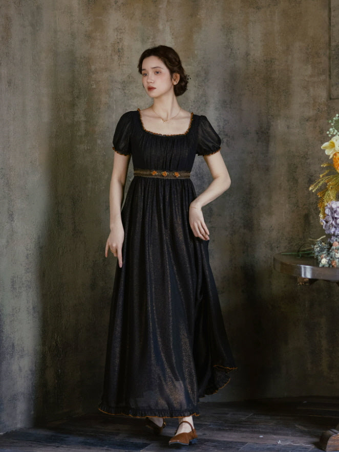 Black vintage maxi dress with puff sleeves, square neckline and delicate floral waist trim in a dark romantic interior