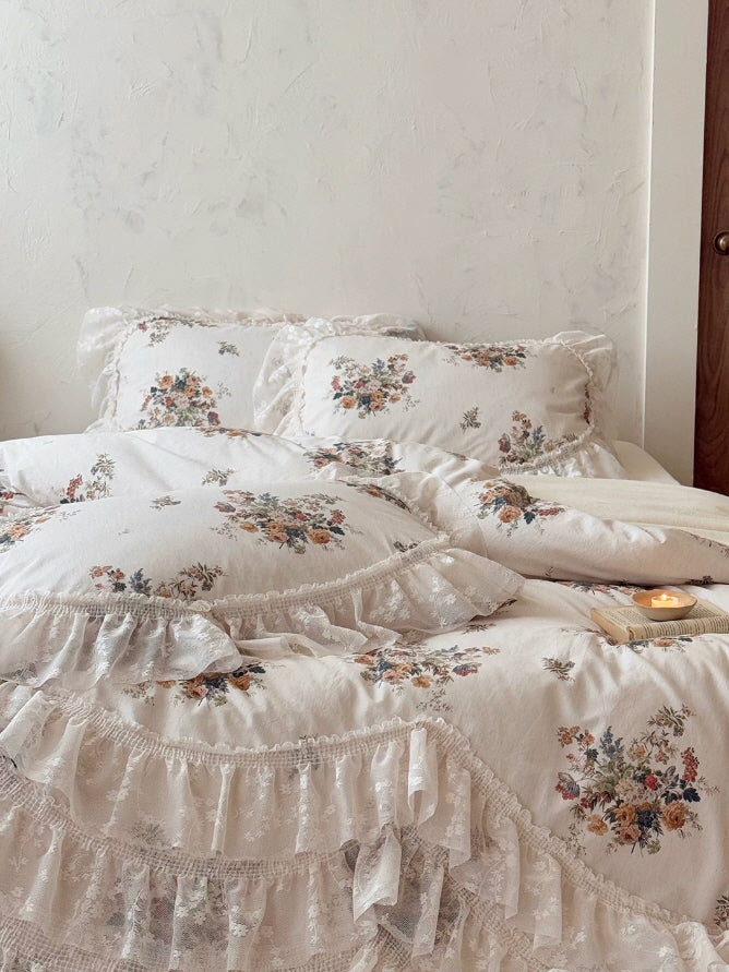 Cottagecore floral bedding set featuring scattered garden bouquets, soft lace frills, and an elegant ivory vintage aesthetic