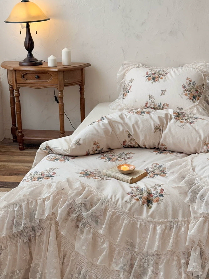 Romantic floral lace bedding set with cascading ruffles, antique inspired bouquet print, and a soft fairytale bedroom aesthetic