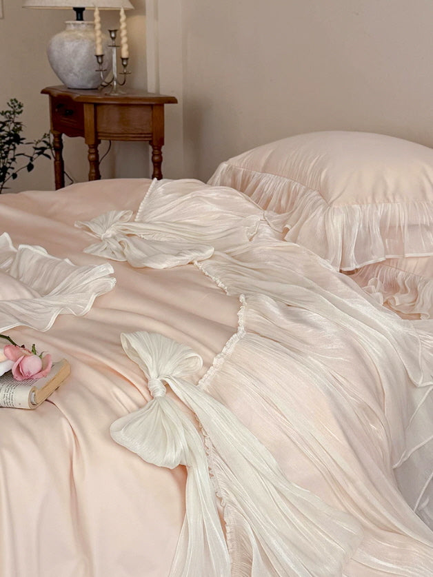 Dreamy blush pink bedding with oversized ivory bows and romantic princesscore styling