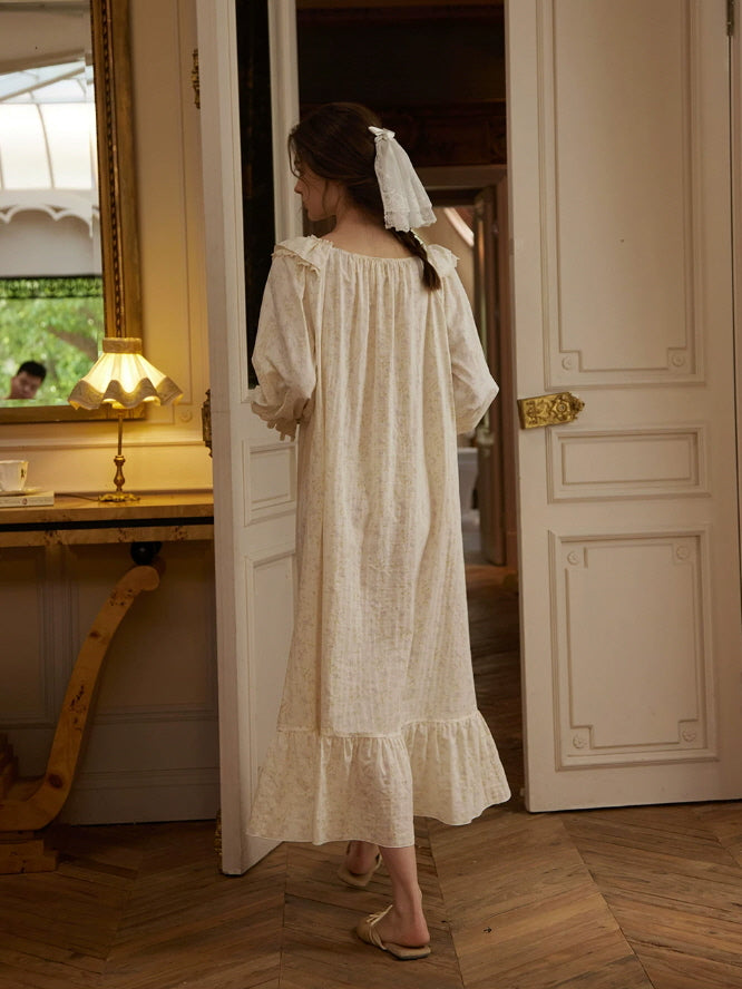Back view of ivory floral nightgown with loose flowing fit, long sleeves and ruffled maxi hem