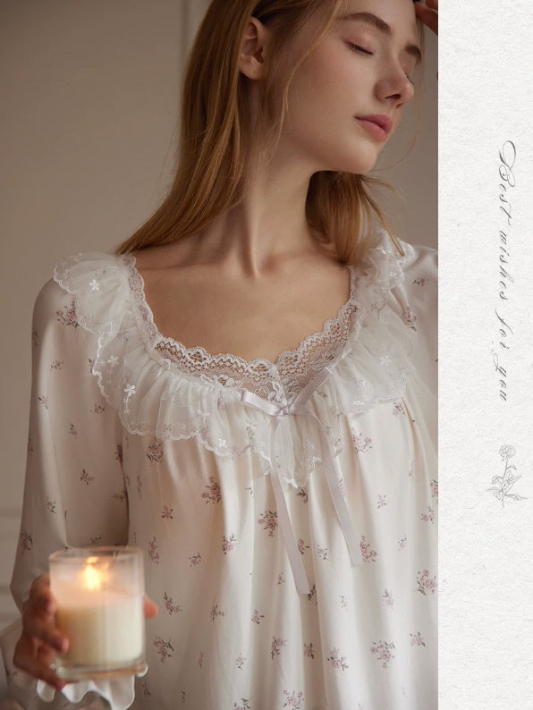Close-up of floral pajama top with embroidered lace ruffle neckline, ribbon bow and vintage inspired details